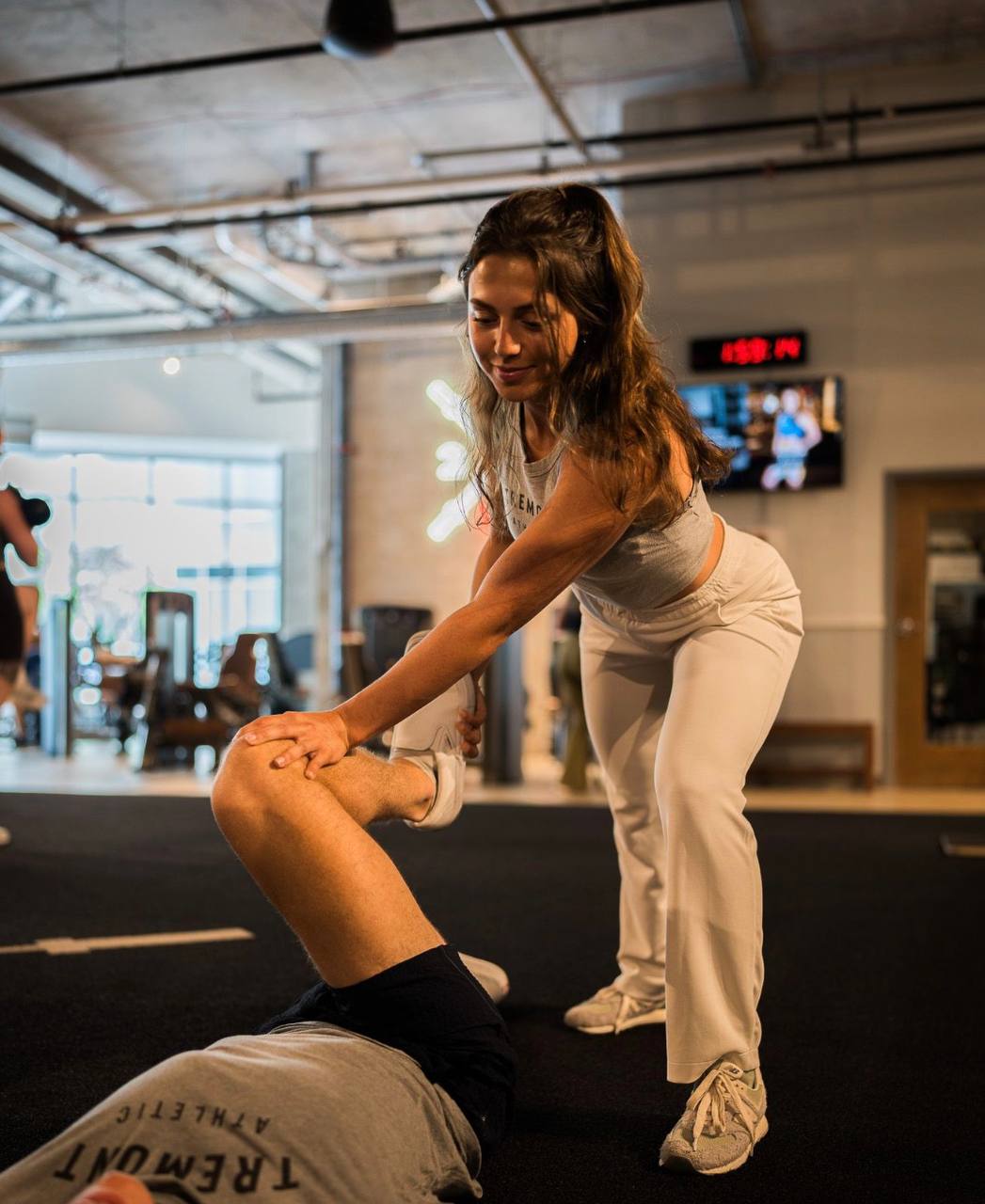 Anna coaching a client through a lift